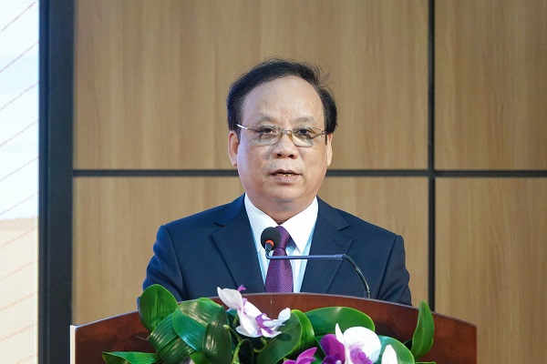 A person in a suit and tie speaking at a podiumDescription automatically generated